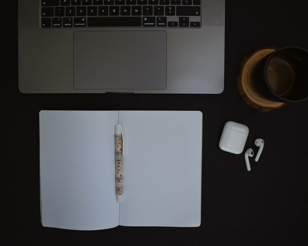 Laptop on a dark desk, pick a plan