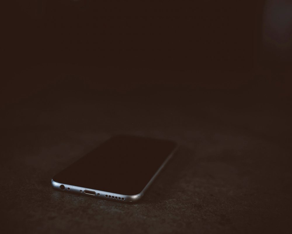 Phone on a dark table, get your key